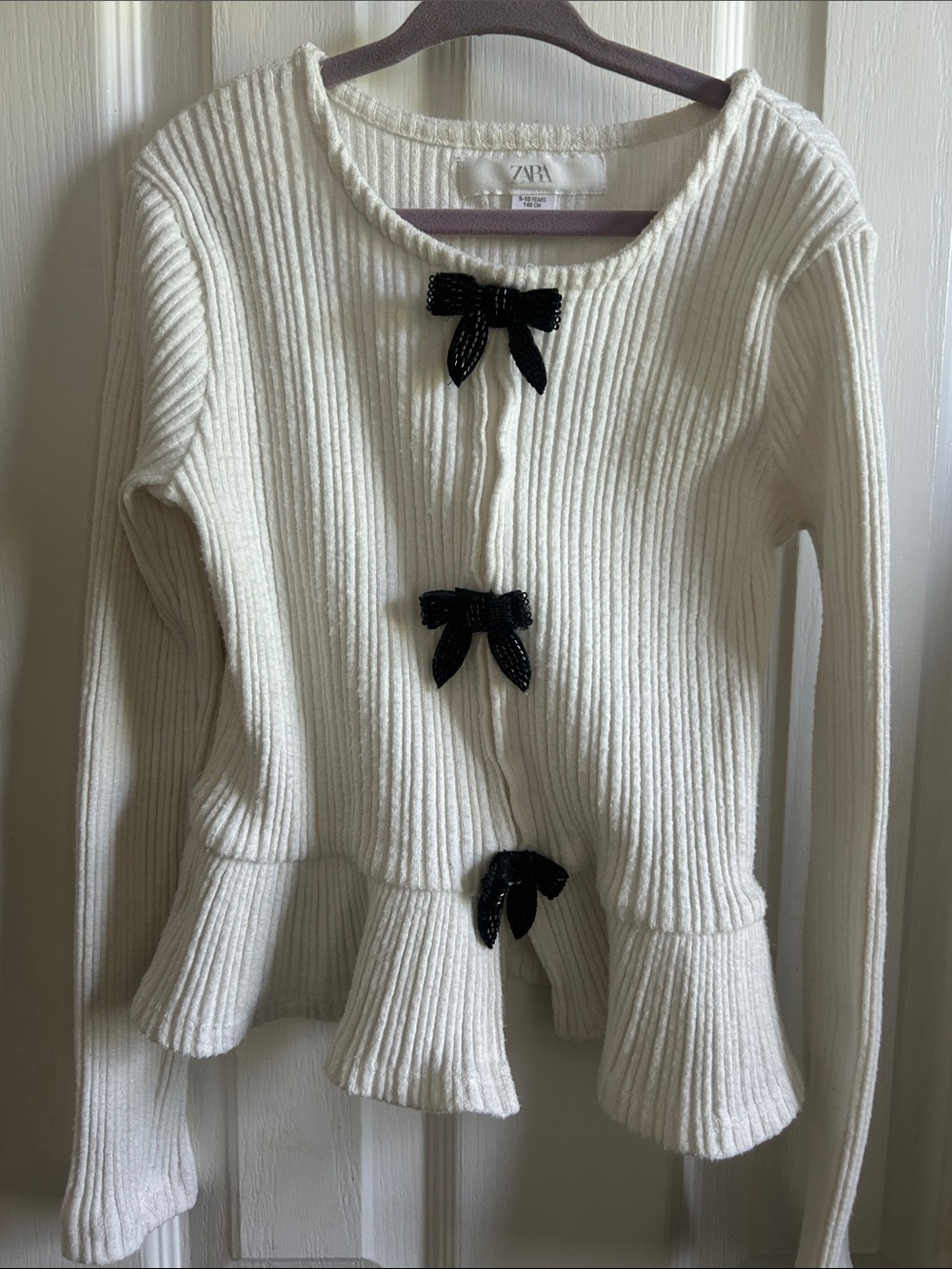 ZARA Girls Cream Ribbed Peplum Sweater with Black Bow Accents